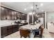 Open kitchen features stainless steel appliances, an island with seating, and dark wood cabinets at 14481 W Via Del Oro --, Surprise, AZ 85379