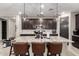Spacious kitchen island with granite countertop, pendant lights, and dark wood cabinets at 14481 W Via Del Oro --, Surprise, AZ 85379