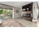 Open-concept living area with fireplace, entertainment center, and sliding door access to the backyard at 14481 W Via Del Oro --, Surprise, AZ 85379