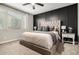 Comfortable main bedroom with upholstered headboard, decorative wall, and neutral carpet at 14481 W Via Del Oro --, Surprise, AZ 85379