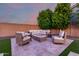 Outdoor patio area with comfortable seating surrounding a stone fire pit at 14481 W Via Del Oro --, Surprise, AZ 85379