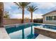 Gorgeous pool featuring stone accents, a spa, and water features, surrounded by lush landscaping at 14481 W Via Del Oro --, Surprise, AZ 85379