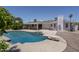 Backyard showcasing a pool, covered patio, and well-maintained gravel landscaping at 1541 E Glencove St, Mesa, AZ 85203