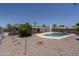 Backyard showcasing a pool, covered patio, and well-maintained gravel landscaping at 1541 E Glencove St, Mesa, AZ 85203