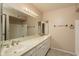 Bathroom featuring double sinks, marble countertops and a large mirror at 1541 E Glencove St, Mesa, AZ 85203