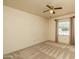 Neutral bedroom featuring a ceiling fan, window, and carpet at 1541 E Glencove St, Mesa, AZ 85203