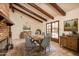 Dining area with vaulted ceilings and exposed beams, with French doors opening to the backyard pool at 1541 E Glencove St, Mesa, AZ 85203