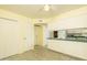 A kitchen area featuring white cabinets, a ceiling fan and access to a dining area at 1541 E Glencove St, Mesa, AZ 85203