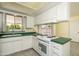 Kitchen area featuring white cabinets, green countertops and a white oven range at 1541 E Glencove St, Mesa, AZ 85203