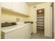 Laundry room featuring a utility sink and a doorway leading to a storage space at 1541 E Glencove St, Mesa, AZ 85203