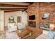 Inviting living room featuring a brick fireplace and vaulted ceilings with exposed beams at 1541 E Glencove St, Mesa, AZ 85203
