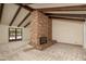 Living room featuring brick fireplace and vaulted ceilings with exposed beams, and access to backyard pool at 1541 E Glencove St, Mesa, AZ 85203