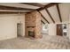 Living room featuring a brick fireplace and vaulted ceilings with exposed beams at 1541 E Glencove St, Mesa, AZ 85203