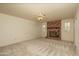 Living room featuring a brick fireplace and neutral-colored walls and carpet at 1541 E Glencove St, Mesa, AZ 85203