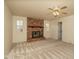 A living room featuring a ceiling fan, a brick fireplace and neutral-colored walls and carpet at 1541 E Glencove St, Mesa, AZ 85203