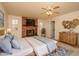 Main bedroom suite with a ceiling fan, a brick fireplace, and an en-suite bathroom at 1541 E Glencove St, Mesa, AZ 85203