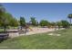 Spacious neighborhood playground with slides and green space under a clear, sunny sky at 1541 E Glencove St, Mesa, AZ 85203