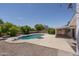 Backyard pool with diving board, lush trees, and refreshing blue water at 1541 E Glencove St, Mesa, AZ 85203
