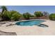 Backyard pool with diving board, lush trees, and refreshing blue water at 1541 E Glencove St, Mesa, AZ 85203