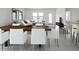 Modern dining area with stylish chairs and table, seamlessly flowing into the living room at 15520 W Corte Del Sol Este --, Waddell, AZ 85355