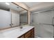 Bathroom featuring a white countertop, wooden vanity, and a glass-enclosed shower at 156 Leisure World --, Mesa, AZ 85206