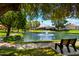 Beautiful community showcasing a peaceful pond with a fountain, surrounded by lush landscaping and walking paths at 156 Leisure World --, Mesa, AZ 85206