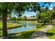 Picturesque community featuring a tranquil pond with a fountain, lush greenery, and scenic walking paths at 156 Leisure World --, Mesa, AZ 85206