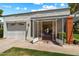 Home exterior showing a two-car garage, gated entry and well kept lawn at 156 Leisure World --, Mesa, AZ 85206