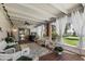 Charming covered patio featuring comfortable wicker furniture, white drapes, and a serene outdoor view at 156 Leisure World --, Mesa, AZ 85206