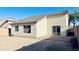 Home exterior featuring a desert backyard with a small patio and a sliding glass door at 1630 W Pecan Rd, Phoenix, AZ 85041