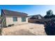 View of the backyard with plants, block wall, and the house in the background on a sunny day at 1630 W Pecan Rd, Phoenix, AZ 85041