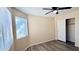 Bright bedroom features a ceiling fan, vinyl floors, and a closet at 1630 W Pecan Rd, Phoenix, AZ 85041
