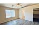 Bright bedroom features a ceiling fan, vinyl floors, and a walk-in closet at 1630 W Pecan Rd, Phoenix, AZ 85041