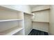 Walk-in closet featuring built-in shelving and racks with modern laminate flooring at 1630 W Pecan Rd, Phoenix, AZ 85041