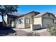 Tan home featuring a tile roof, two-car garage, and desert landscaping at 1630 W Pecan Rd, Phoenix, AZ 85041