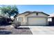 Home exterior featuring a desert landscape with mature shrubbery and a two-car garage at 1630 W Pecan Rd, Phoenix, AZ 85041