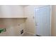 Laundry room with a shelf above the connections, a security system keypad, and neutral walls at 1630 W Pecan Rd, Phoenix, AZ 85041