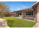 Backyard featuring artificial turf and patio with pergola shade structure at 16417 S 43Rd Pl, Phoenix, AZ 85048