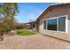 Landscaped backyard with artificial turf, rock ground cover, and a covered patio at 16417 S 43Rd Pl, Phoenix, AZ 85048