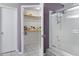 Bathroom view showcasing walk-in closet, shower, and neutral-toned decor at 16417 S 43Rd Pl, Phoenix, AZ 85048