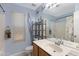 Bright bathroom with white tile, neutral wall color, and a large mirror at 16417 S 43Rd Pl, Phoenix, AZ 85048