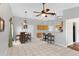 Open dining space with tile flooring, a ceiling fan, and a bar area with seating at 16417 S 43Rd Pl, Phoenix, AZ 85048