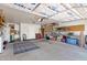 Spacious garage featuring overhead door, storage cabinets, and shelving at 16417 S 43Rd Pl, Phoenix, AZ 85048