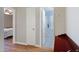 Hallway with wood floors leading to a bedroom and bathroom at 16417 S 43Rd Pl, Phoenix, AZ 85048