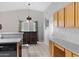 Kitchen and bar area with bar seating, oak cabinets, and tile flooring at 16417 S 43Rd Pl, Phoenix, AZ 85048