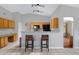 Open kitchen with light wood cabinets, black appliances, breakfast bar, and tile flooring at 16417 S 43Rd Pl, Phoenix, AZ 85048
