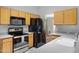 Updated kitchen with black appliances, stainless steel oven, and oak cabinets at 16417 S 43Rd Pl, Phoenix, AZ 85048
