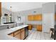 Bright kitchen featuring gray counters, white tile floors, and wooden cabinets at 16417 S 43Rd Pl, Phoenix, AZ 85048