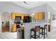 Bright kitchen with oak cabinets, breakfast bar, black appliances, and neutral countertops at 16417 S 43Rd Pl, Phoenix, AZ 85048