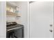 Laundry area featuring a black washing machine and plenty of shelving at 16417 S 43Rd Pl, Phoenix, AZ 85048